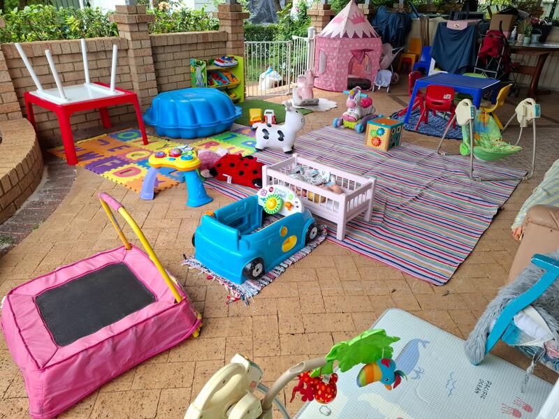 Covered patio play space at Aunty Joy's family day care in the Perth Hills, WA with toys and play mats